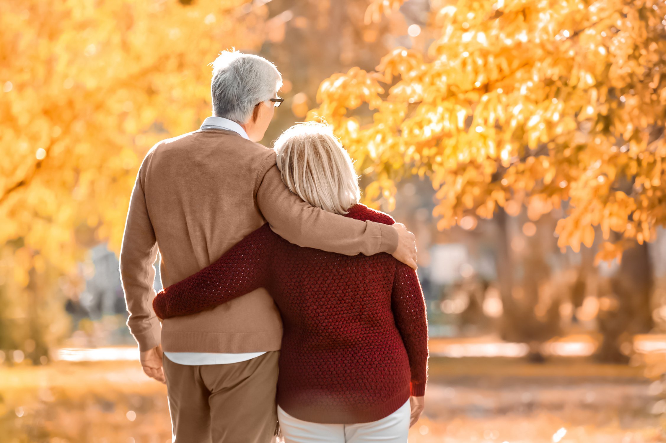 Cute Elderly Couple Walking in Autumn Park